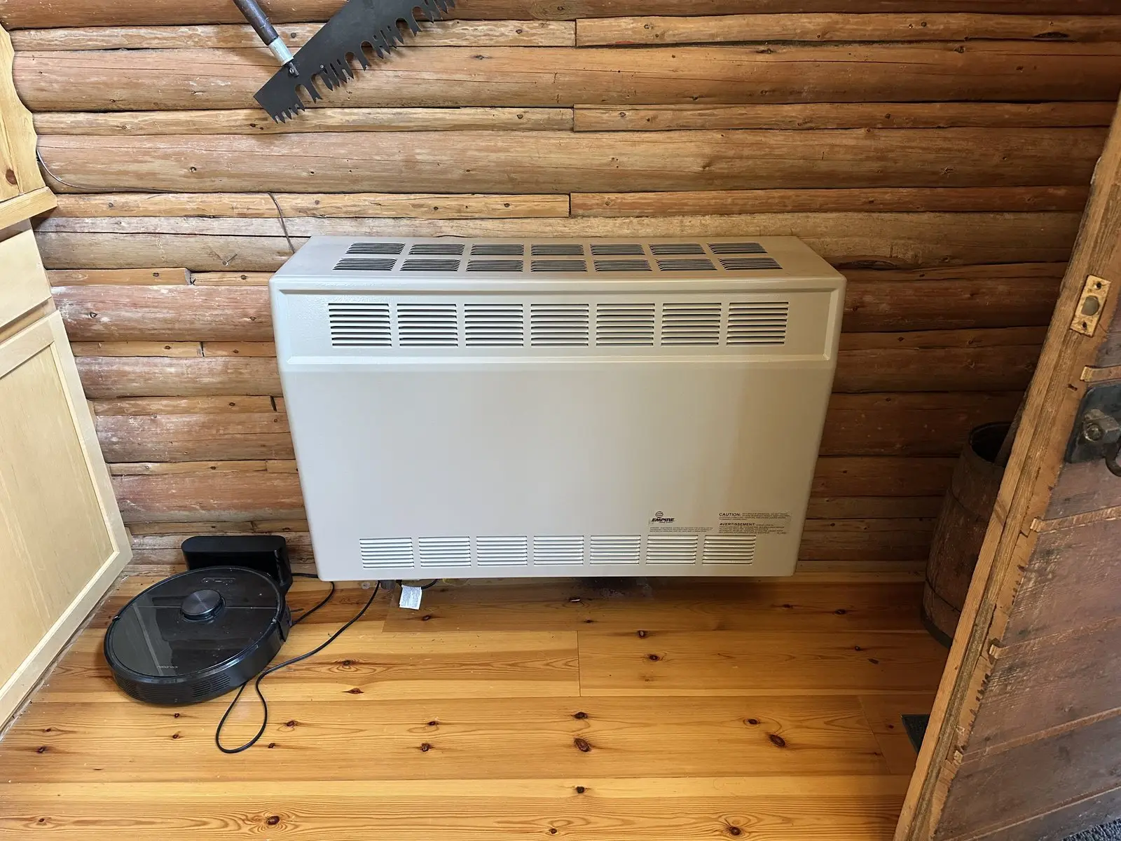 Wall heater installed in log cabin